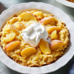 A delicious peach dump cake with a golden, crispy topping served in a baking dish.