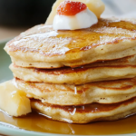 Fluffy Oatmeal Egg Pancakes served with fresh fruit and syrup for a healthy breakfast