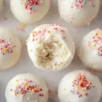 Homemade cake balls coated in chocolate with colorful sprinkles